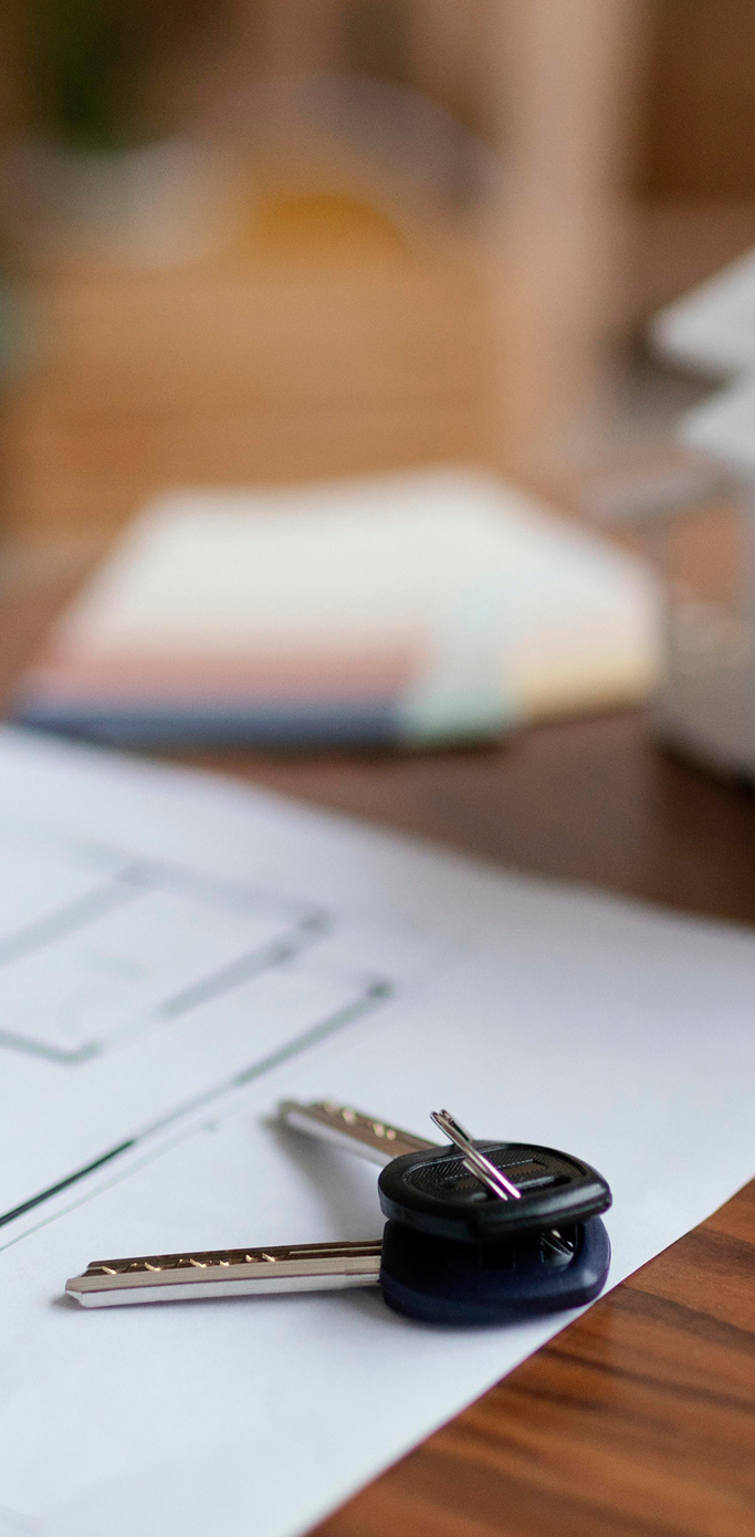 Buying property in the UK – legal help for Poles House keys and blueprint representing real estate transactions for Polish clients in the UK
